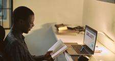 Man sits at computer studying - emmanuel-ikwuegbu