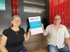 BASW Chief Executive Ruth Allen and SWU General Secretary John McGowan each hold a side of the new BASW/SWU Co-operation Agreement (signed 10 June 2021) while remaining socially distanced due to COVID-19 regulations.