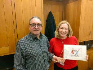 SWU General Secretary John McGowan presents Emma Lewell-Buck MP with the SWU Ambassador Award and a personalized "Clare in the Community" cartoon on 15 December 2021 in her Westminster office.