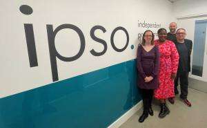 A photo of staff from SWU, IPSO, and Campaign Collective standing in front of the "IPSO" sign at the IPSO office in London