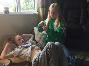 Hayley Gwilliams' photo of her nine-year-old daughter administering medicine to her eight-year-old brother who has multiple health issues Hayley Gwilliams' photo of her nine-year-old daughter administering medicine to her eight-year-old brother who has multiple health issues