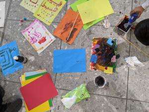 A child engages in art therapy after arriving from Afghanistan to the UK