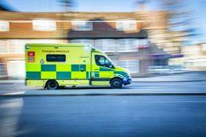 An ambulance racing down a street